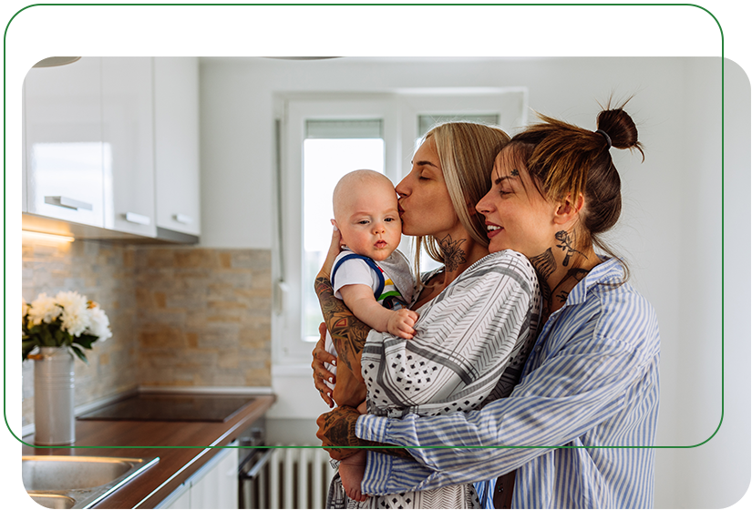 Same-sex couple with their baby in the family's new kitchen 