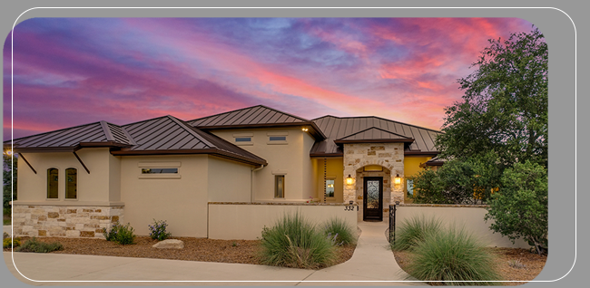 beautiful southwestern rancher home with metal roof at sunset