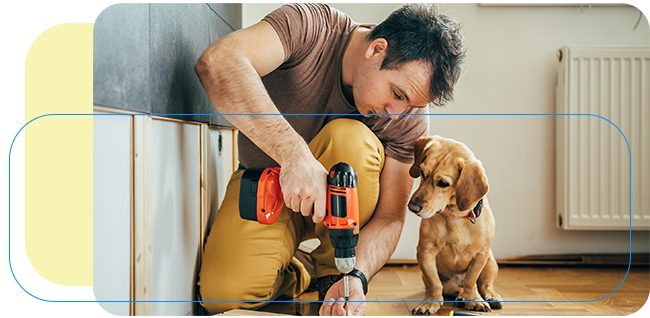 man doing home improvement work while his cute dog watches